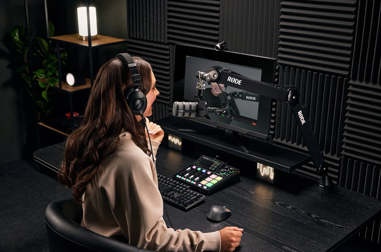 Creator at a RØDECaster desk in a treated studio